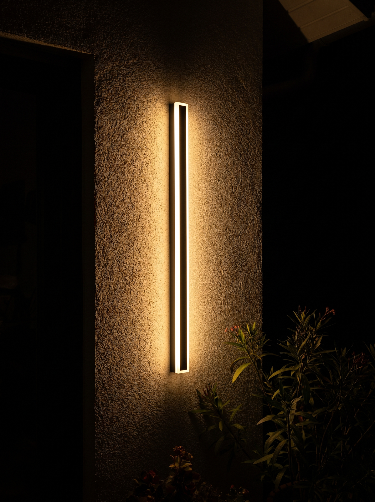Slim Bar Outdoor Wall Light lit at night
