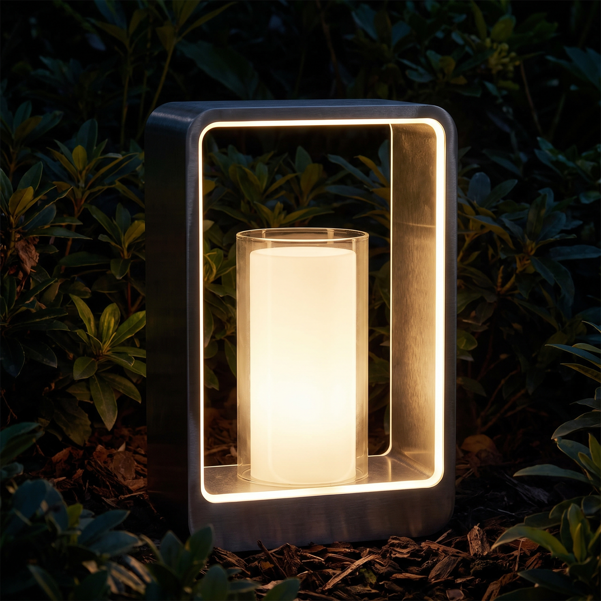 Square frame landscape light at night outlining itself against planting