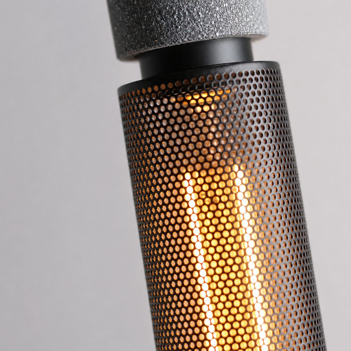 Varo concrete pendant lit, showing the downward light spread